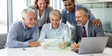 Group of diverse individuals discussing retirement planning documents on a tablet.